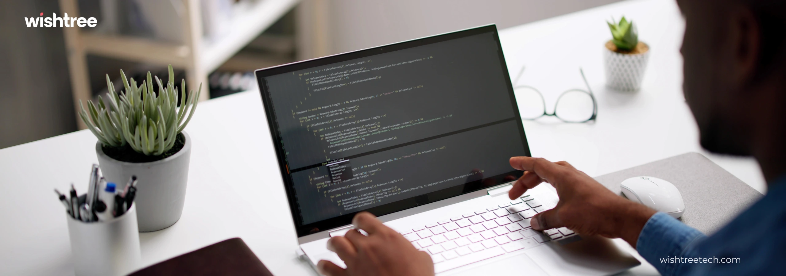 A person is working on a laptop in an indoor setting. The scene may feature a focus on the individual and their use of technology, emphasizing design and productivity. The content is related to wishtree, specifically from wishtreetech.com