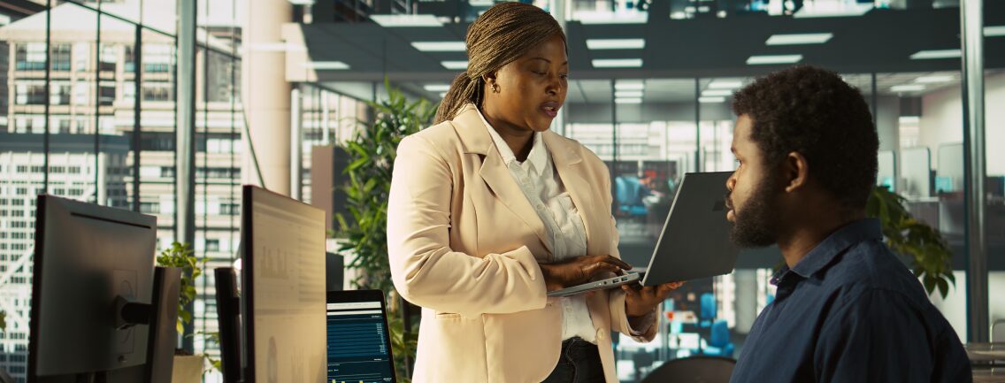 Enterprise SaaS modernization team discussing a legacy overhaul for a B2B commerce platform in a modern office.